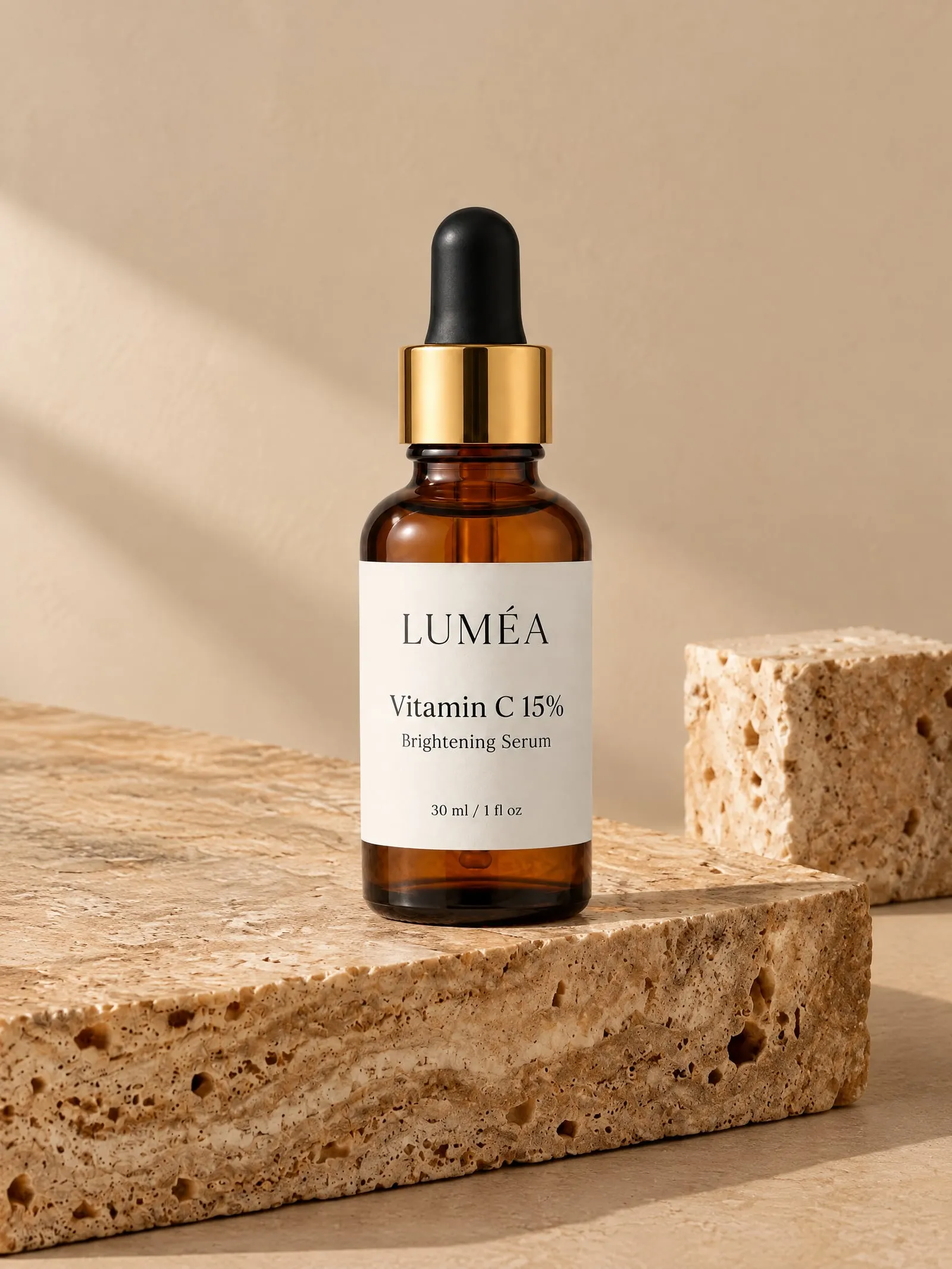 The LUMÉA vitamin C serum, front view, on travertine stone