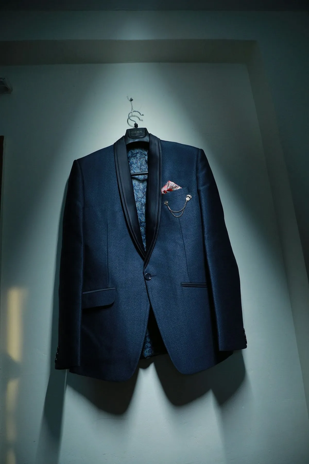 The navy shawl-collar blazer, the product photo the shoot started from